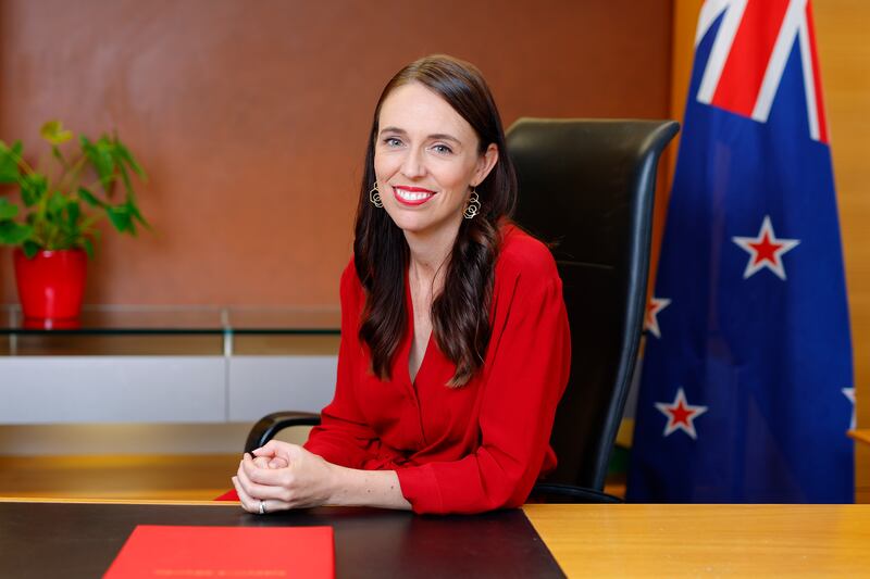 Jacinda Ardern poses at her desk for the last time as New Zealand prime minister at the parliament in Wellington. Getty 