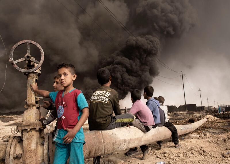 Iraq, Qayyara: On October 2016 children are seen in Qayyara where IS fighters set on fire crude oil fields as they retreated. Alessio Romenzi