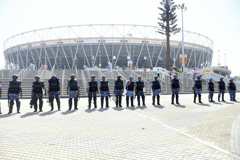 Para-military soldiers from the Rapid Action Force stand in front of Sardar Patel Stadium, in Motera, on the outskirts of Ahmedabad, on February 21, 2020. - US President Donald Trump will open the world's biggest cricket stadium in India next week, but critics wonder whether it's just another vanity project by Prime Minister Narendra Modi in his home state. (Photo by SAM PANTHAKY / AFP)