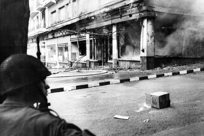 A French soldier looks at a shop destroyed by a Molotov cocktail in Algiers in May 1962, after the signing of the Evian Accords. AFP