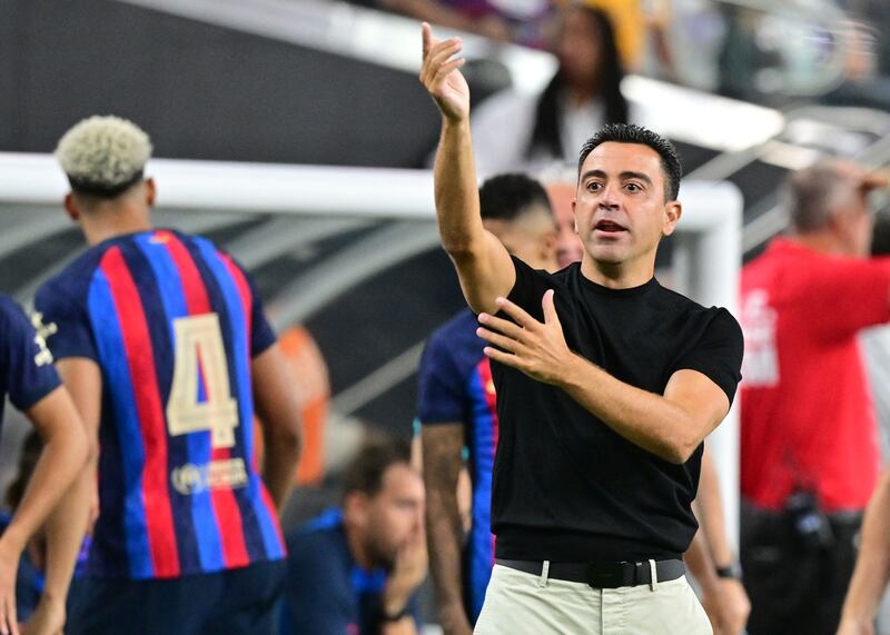 Barcelona manager Xavi appeals to officials for a handball against Real Madrid. AFP