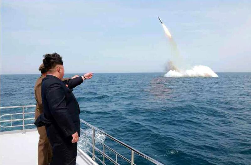 North Korean leader Kim Jong-un cheers the launch of a ballistic missile. EPA