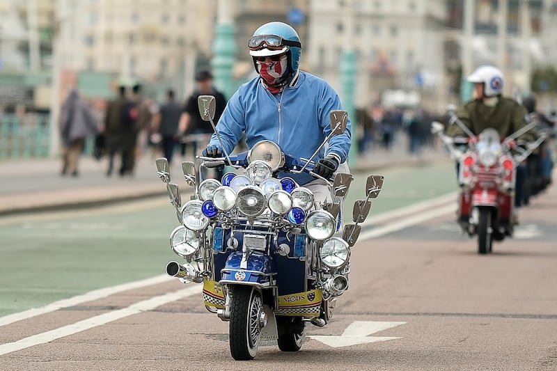 A scooter rider makes his way down Madeira Drive in Brighton, England. Getty images
