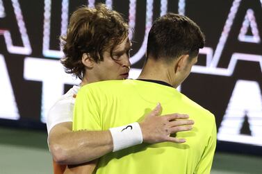 Russia's Andrey Rublev (L) speaks with Poland's Hubert Hurkacz after their semi-final match at the ATP Dubai Duty Free Tennis Championship, in the Gulf emirate on February 25, 2022.  (Photo by Karim SAHIB  /  AFP)