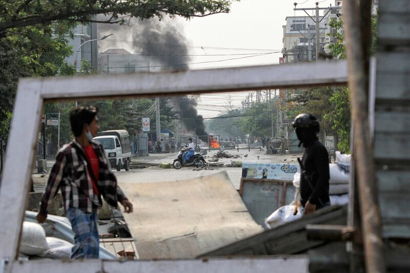 Demonstrators are seen behind barricades during a protest against the military coup in Mandalay. Reuters