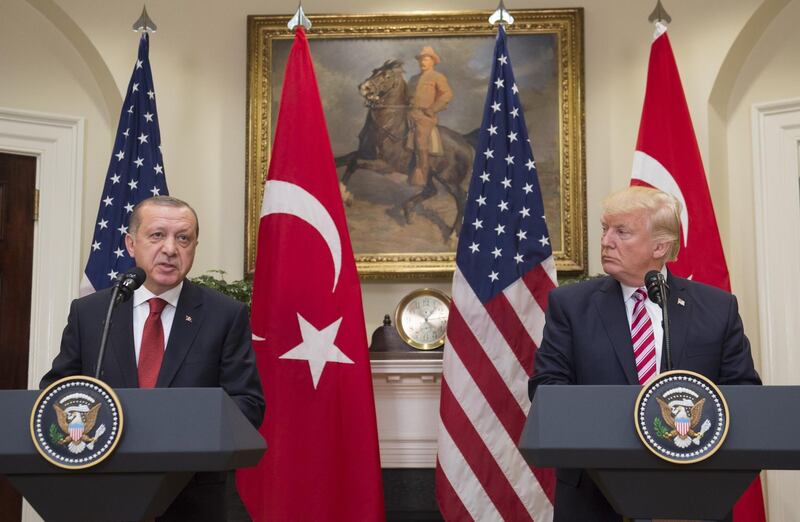 (FILES) In this file photo taken on May 16, 2017 US President Donald Trump and Turkish President Recep Tayyip Erdogan speak to the press in the Roosevelt Room of the White House in Washington, DC. Facing a backlash for appearing to greenlight Turkey's assault against Kurdish forces in Syria, President Donald Trump on October 11, 2019 dialed up pressure on America's NATO ally by threatening crippling sanctions. / AFP / SAUL LOEB
