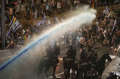 Riot police try to clear demonstrators with a water cannon during a protest against judicial overhaul in Jerusalem on Monday. AP