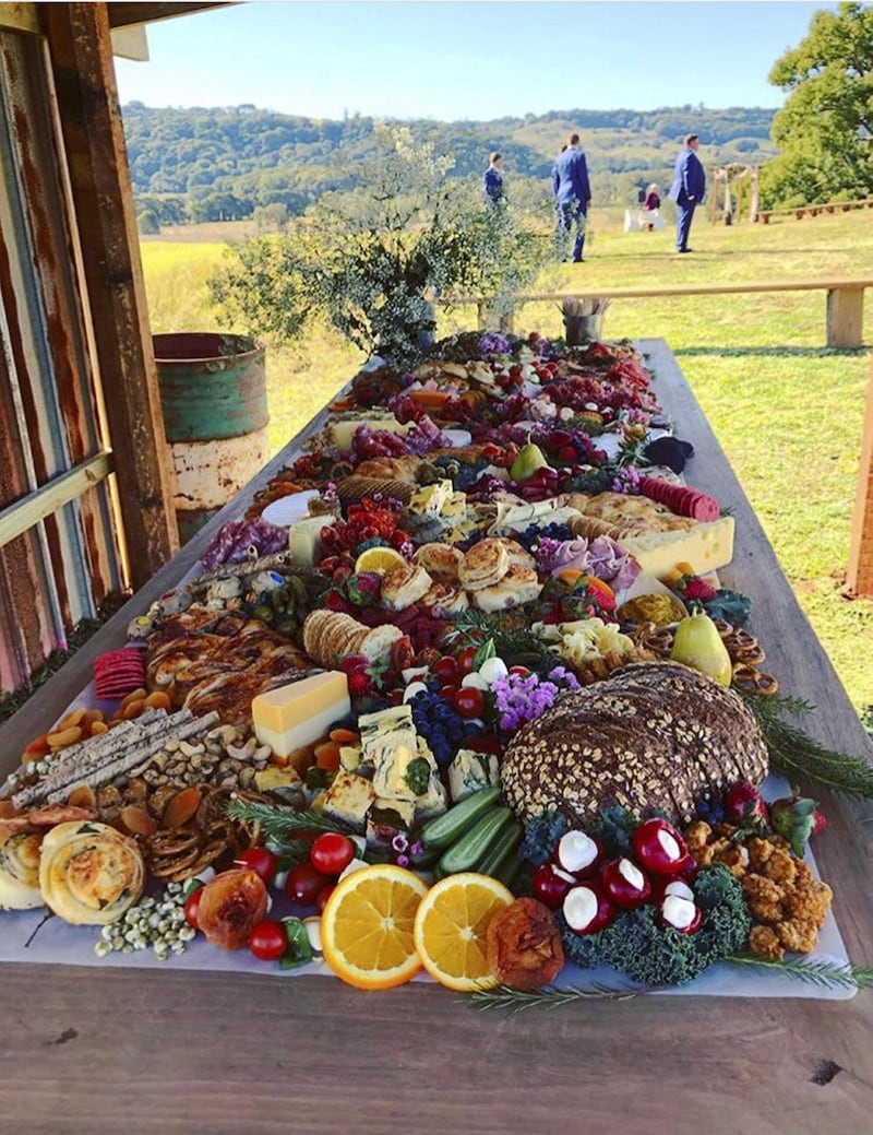 An outdoor grazing table set up by All That Platters, a catering company specialising in “perfect platters and amazing grazing” based in New South Wales, Australia, where the trend originated 