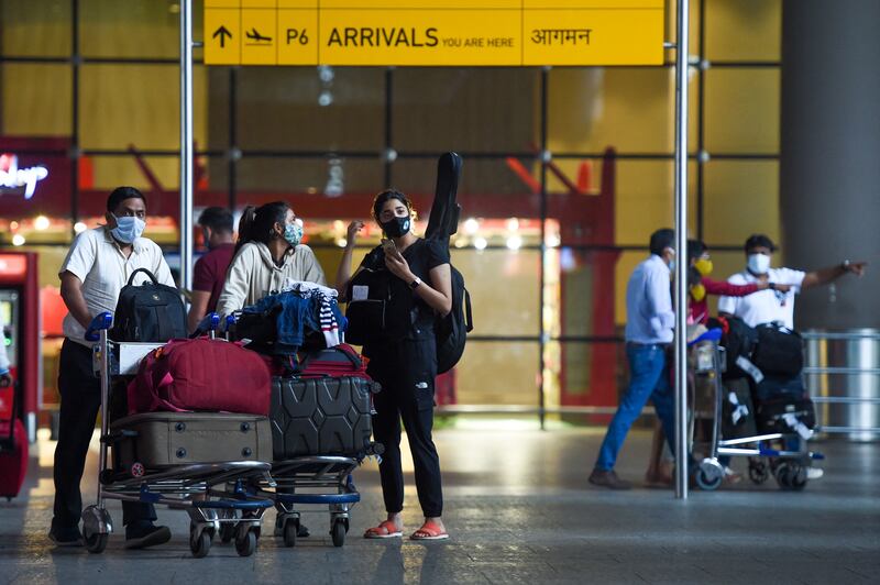 Arriving passengers leave a terminal at the Chhatrapati Shivaji Maharaj International Airport in Mumbai on December 1, 2021. AFP