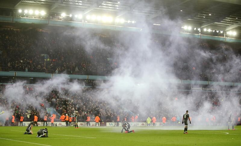 Leicester players dejected as smoke passes from flares after Aston Villa's second goal scored by Trezeguet. Reuters