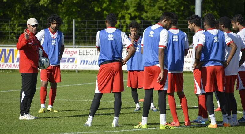 Mahdi Ali, left, the UAE coach, speaks with players during a training session in Switzerland. Courtesy UAE FA
