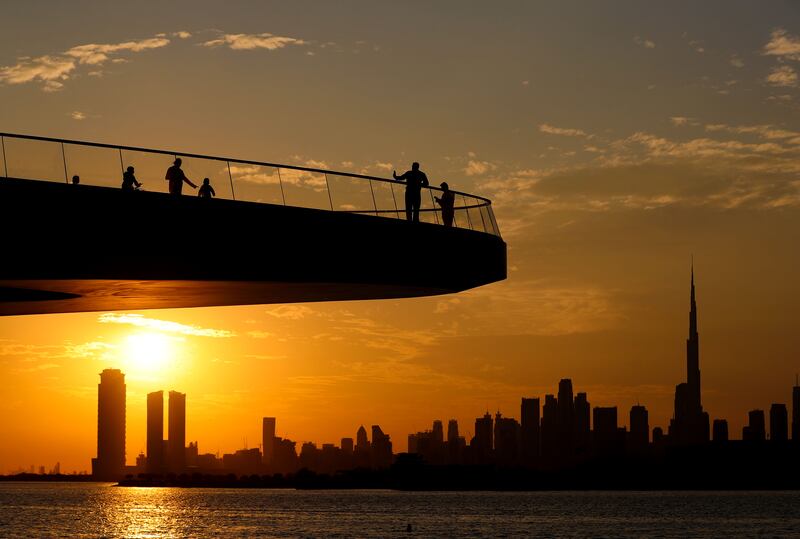The jutting viewing deck and Dubai's skyline silhouetted at sunset. Chris Whiteoak / The National