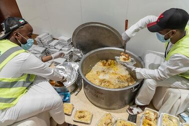 Volunteers prepare food to help the needy break their fast at iftar time. Antonie Robertson / The National) 