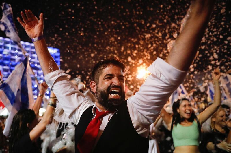 People celebrate after Israel's parliament voted in a new coalition government, ending Benjamin Netanyahu's 12-year hold on power, at Rabin Square in Tel Aviv, Israel. Reuters