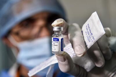 A medical worker holds a vial of Russia's Sputnik V vaccine for COVID-19 coronavirus disease at a clinic in the city of Blida, about 45 kilometres southwest of the Algerian capital, on January 30, 2021, where the North African country is symbolically starting its vaccination drive at the same place to have registered the first novel coronavirus case in 2020. At the end of December, Algiers announced an order of 500,000 doses of Sputnik V vaccine from its Russian ally. / AFP / RYAD KRAMDI                        
