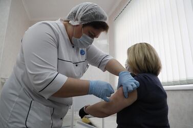 A Russian medic innoculates a patient with the Sputnik V shot. EPA