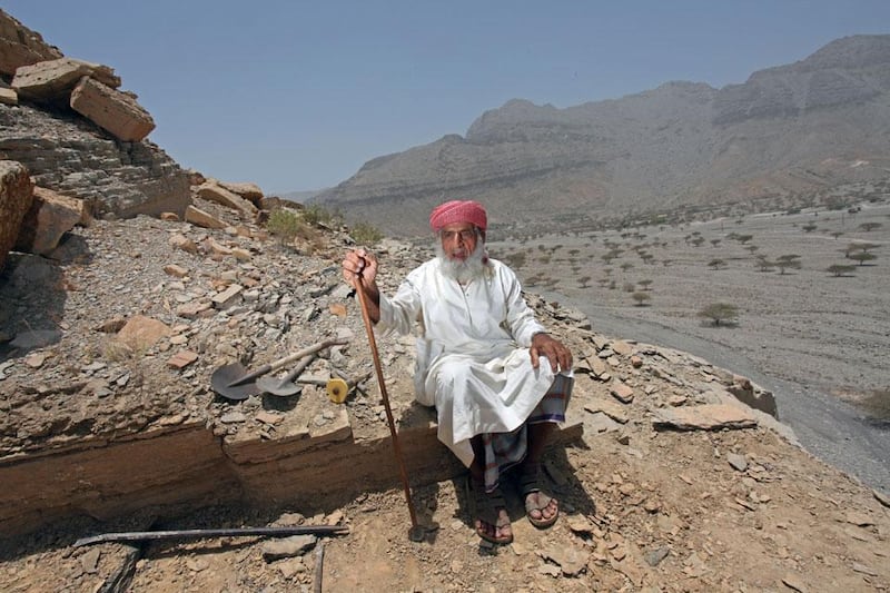 RAS AL KHAIMAH, UNITED ARAB EMIRATES - MAY 30:  82-year-old Ali Rashid Al Dhuhoori, at his place of work in the village of Wadi Shaam located outside of Ras Al Khaimah, on May 30, 2010. Ali is the village headstone maker and each day he climbs his mountain to access the rock which he then cuts for the tombs.  (Randi Sokoloff / The National)  For News story by Rym TIna Ghazal