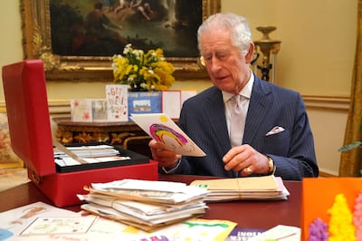 Britain's King Charles reads cards and messages, sent by well-wishers following his cancer diagnosis, in London last month. Reuters