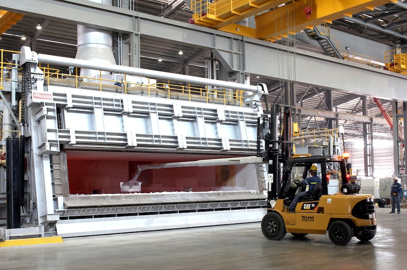 Workers at the Emirates Global Aluminum plant in Abu Dhabi. Improved operational performance throughout the value chain and a focus on efficiency helped boost EGA's profitability. Rich-Joseph Facun/ The National