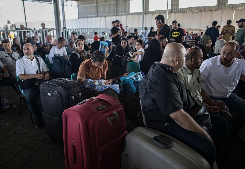 Palestinians wait to cross into Egypt at the Rafah border on November 1. EPA