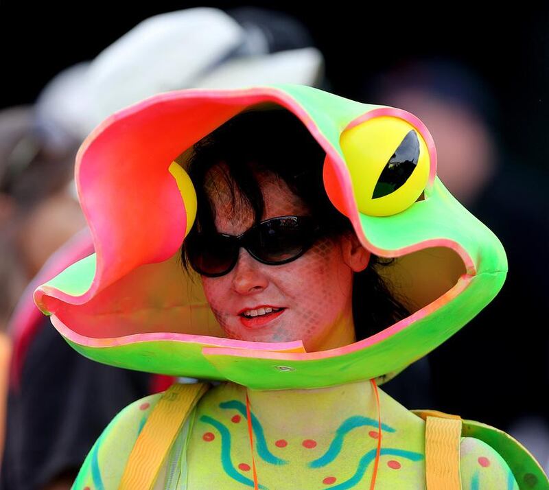 A fan dressed in a gecko costume attends Dubai Sevens on the final day of the event on Saturday. Satish Kumar / The National