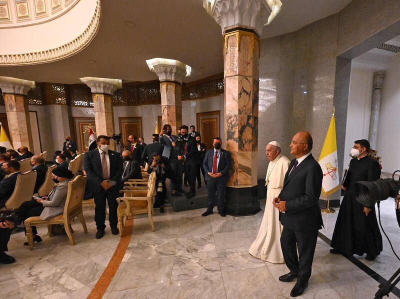 Pope Francis and Iraqi President Barham Salih enter the Presidential Palace during the first papal visit to Iraq. AFP