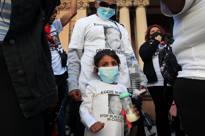 A young child attends the 'Black Lives Matter' march with her family on June 6, 2020 in Sydney, Australia. Getty