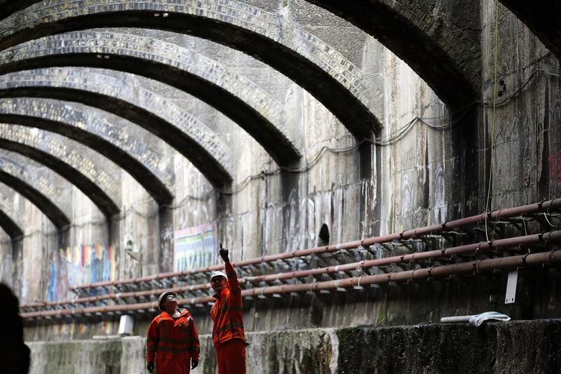 Crossrail project supervisors look at the roof of an old Victorian tunnel, built in 1879 but has been derelict since 2006, which is being brought back into use for the Crossrail project. Adrian Dennis / AFP