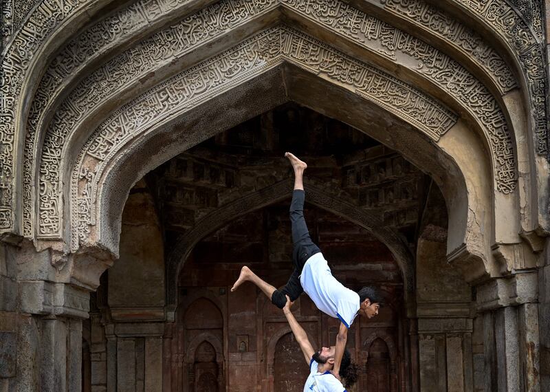 Youth enthusiasts take part in a yoga session at Lodhi gardens on International Day of Yoga, in New Delhi on June 21, 2023.  (Photo by ARUN SANKAR  /  AFP)