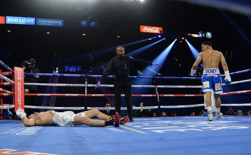 Rolando Romero (blue trunks) knocks down Arturs Ahmetovs (white trunks) during their lightweight bout at MGM Grand Garden Arena, Las Vegas.  Reuters