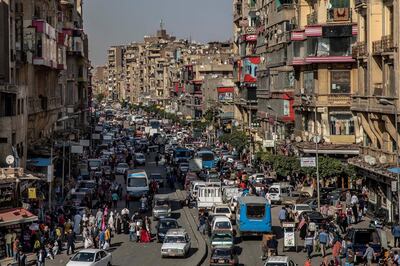 FILE - In this Tuesday, April 14, 2020 file photo, people crowd a street a few hours ahead of curfew in Cairo, Egypt. Wealthier Western countries are considering how to ease lockdown restrictions and start taking gradual steps toward reviving business and daily life. But many developing countries, particularly in the Middle East and Africa, can hardly afford the luxury of any misstep. In Egypt, the Arab worldâ€™s most populous country where one in three people lives in poverty, the government opted for a partial lockdown that includes a nighttime curfew, fearing that a full closure would devastate a fragile economy. (AP Photo/Nariman El-Mofty, File)