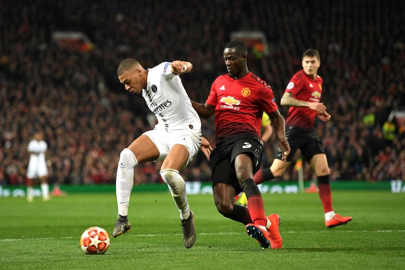 Paris Saint-Germain's Kylian Mbappe is tackled by Manchester United's Eric Bailly. Getty Images