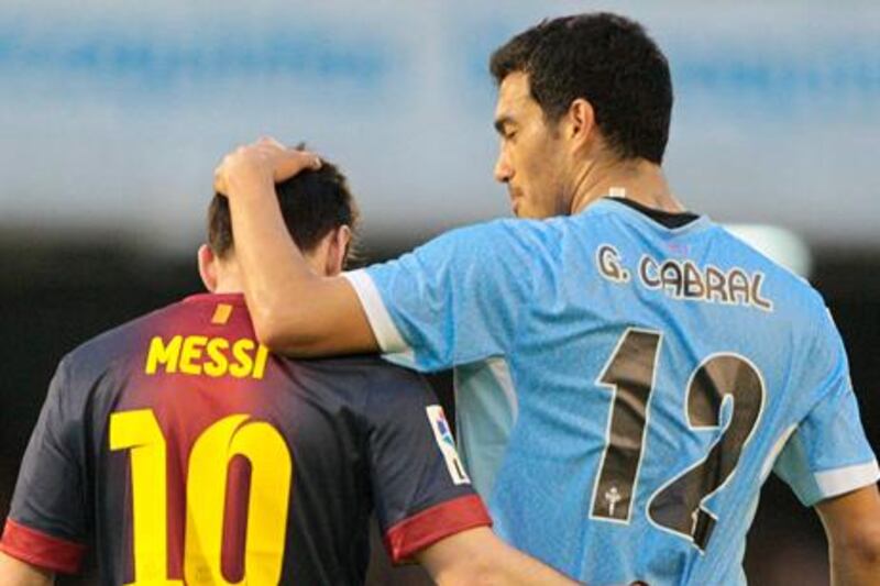 Barcelona´s Lionel Messi is congratulated by Celta's Gustavo Cabral after his record-breaking goal.