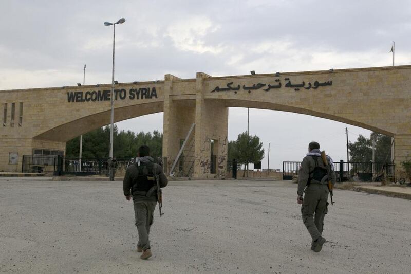 Members of the Kurdish People's Protection Units stand near Al Yaroubia crossing in the province of Hasakah. Reuters