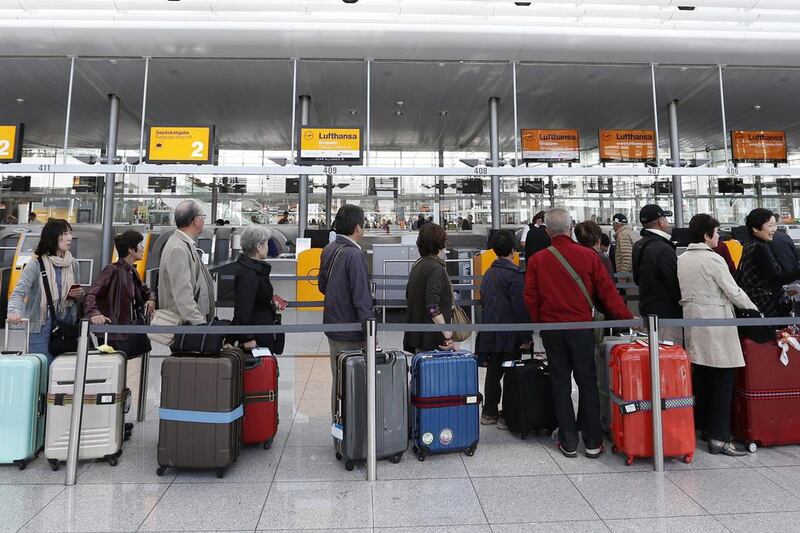 Passengers await their check-in for German airline Lufthansa at Munich airport on October 20, 2014. Michaela Rehle / Reuters
