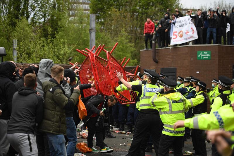 United fans clash with police outside of Old Trafford. AFP
