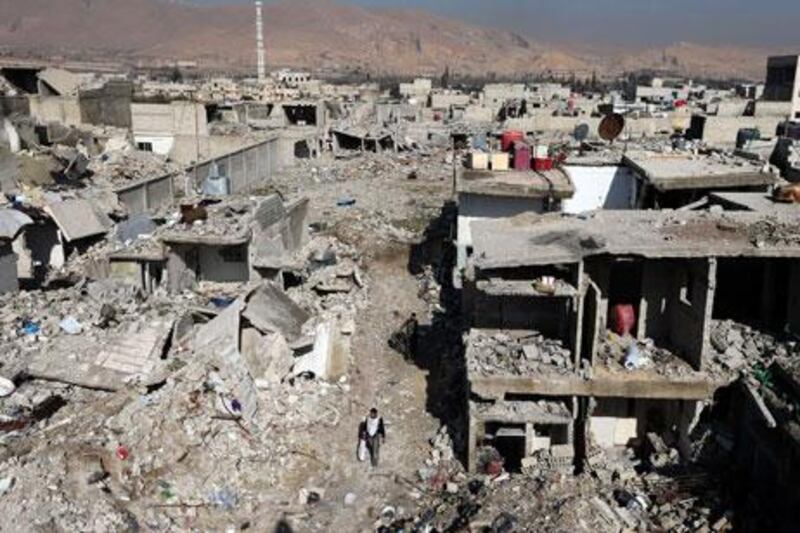 A man passes by buildings destroyed by Syrian air force air strikes in Damascus last month. Many places in the capital have had their character dramatically transformed by 22 months of revolt and war, just as Syria itself has been reshaped in the tumult of revolution. Goran Tomasevic / Reuters