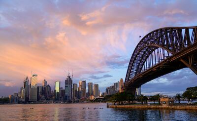 The sun rises over the central business district of Sydney. AP