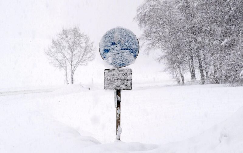 A traffic sign is snow covered near Grossweil, Bavaria, Germany. EPA