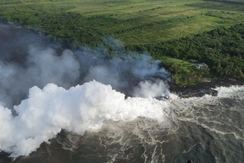 Hot lava entering the Pacific Ocean creates a dense white plume called 'laze', short for lava haze, in southeast of Pahoa, during ongoing eruptions of the Kilauea Volcano in Hawaii, U.S., May 20, 2018.   Picture taken May 20, 2018.   USGS/Handout via REUTERS    ATTENTION EDITORS - THIS IMAGE HAS BEEN SUPPLIED BY A THIRD PARTY.
