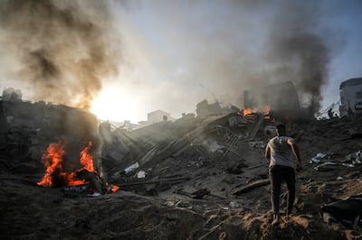 Smoke rises in an area in Gaza city destroyed in Israeli air strikes. EPA 