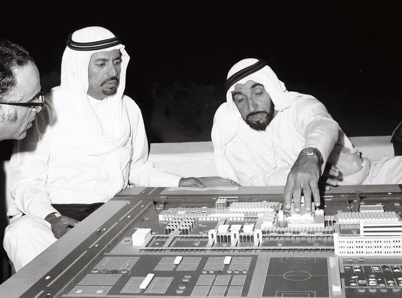 Sheikh Zayed looking at a model of an Islamic City with a number of officials in the early 1970s. (National Center for Documentation & Research)