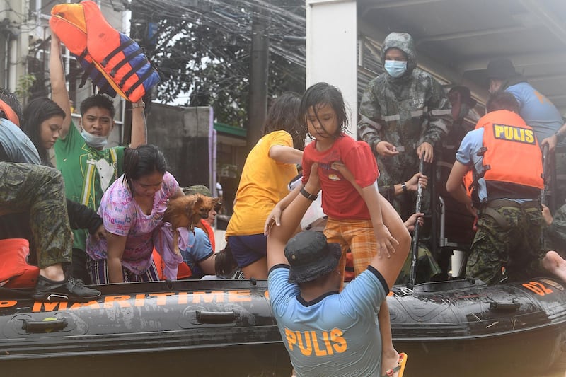 Rescuers evacuate residents from their flooded homes after Typhoon Vamco hit, in Marikina City, Metro Manila, Philippines. AFP
