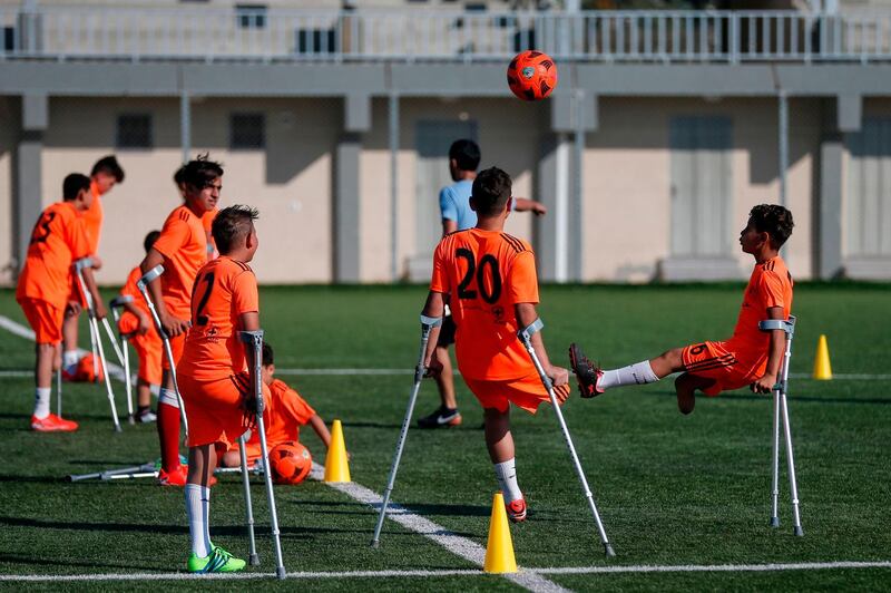 Palestinian amputee children participate in a football training session, arranged by the Red Cross, after the easing of coronavirus restrictions, in Deir Al Balah in the central Gaza Strip.   AFP