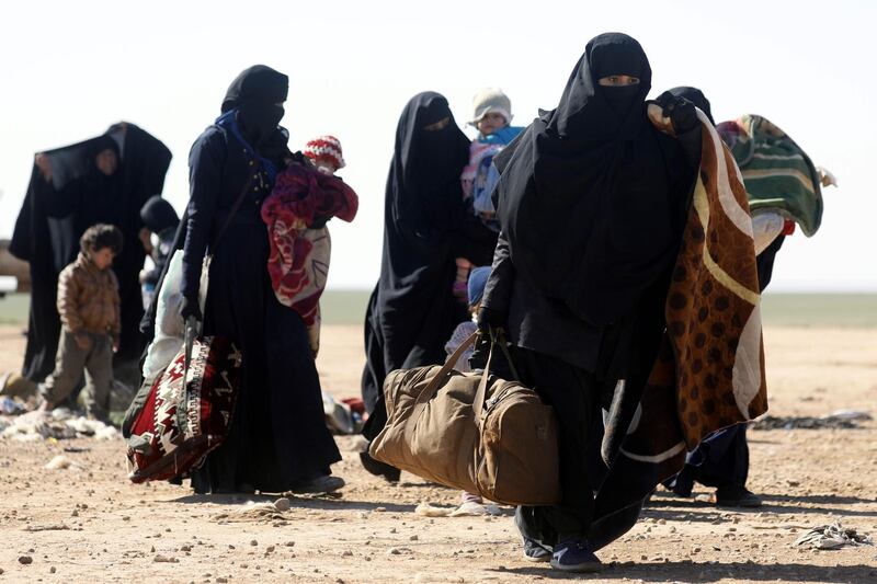 Civilians fleeing fighting between Syrian Democratic Forces (SDF) and ISIS militants in the frontline Syrian village of Baghuz, await to be screened and registered by the SDF in the countryside of the eastern Syrian Deir Ezzor province. AFP
