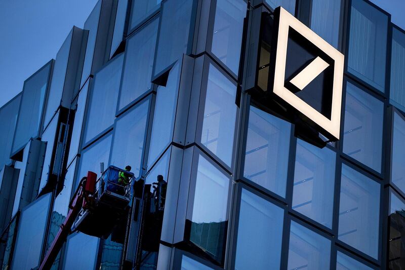 Workers stand on a hydraulic platform as they carry out maintenance on a new Deutsche Bank AG office building in Frankfurt, Germany, on Monday, Nov. 6, 2017. Demand for offices in Frankfurt and prime rents have climbed to a record as the city emerges as one of the favorites to attract financial firms from London in the run-up to the U.K.’s exit from the European Union, according to lobby group Frankfurt Main Finance. Photographer: Krisztian Bocsi/Bloomberg