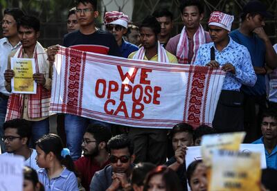 epa08070144 People from the Indian state of Assam hold placards during a protest against the Citizenship (Amendment) Bill (CAB), in Mumbai, India, 14 December 2019. Indian Home Minister Amit Shah on 09 December introduced the Citizenship Amendment Bill in the Lok Sabha (lower house of Parliament) during the winter session of the Indian Parliament. The passing of the bill will give Indian citizenship rights to refugees from Hindu, Jain, Buddhist, Sikhs, Parsi or Christian communities coming from Afghanistan, Bangladesh and Pakistan.  EPA/DIVYAKANT SOLANKI