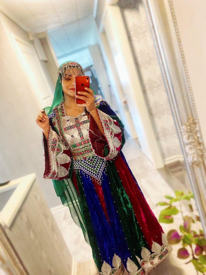 A woman poses in traditional Afghan attire, in Stockholm, Sweden, March 21, 2021, in this picture obtained from social media.  Wazhma Sayle/via Reuters