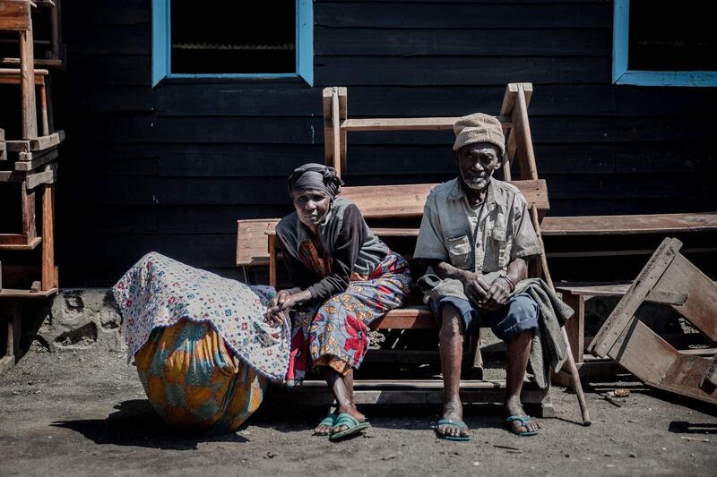 Two elderly people sitting on the roadside in Sake.