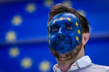 A man wearing face paint in a European Union flag design follows the results of the European Parliament elections in Brussels on May 26, 2019. Geert Vanden Wijngaert / Bloomberg